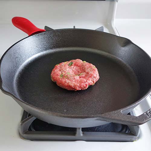 burger meat on cast iron pan